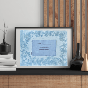 Art made using pigment from real plants depicting a blue backdrop with a typewritten quote by Paramahansa Yogananda on handmade cotton paper on top.