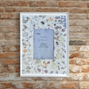 Art made using pigment from real plants as a backdrop. Atop, on handmade cotton paper, is the hand typed action verb, flourish, followed by its definition.