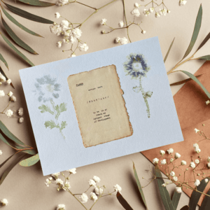 Art made using pigment from real plants as a backdrop. Atop, on handmade cotton paper, is the hand typed action verb, flower, followed by its definition.