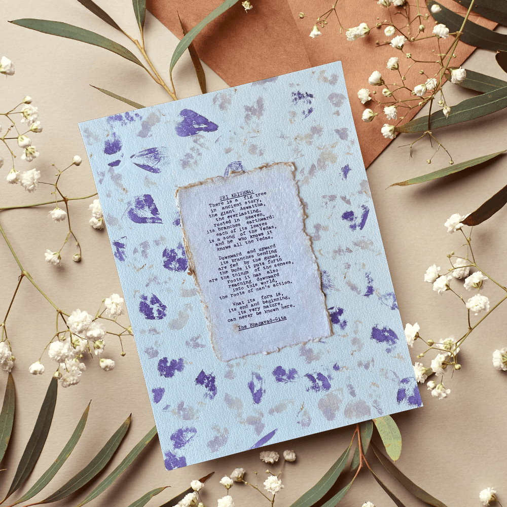 Art made using pigment from real plants depicting a floral backdrop with a typewritten quote from The Bhagavad-Gita on handmade cotton paper on top.