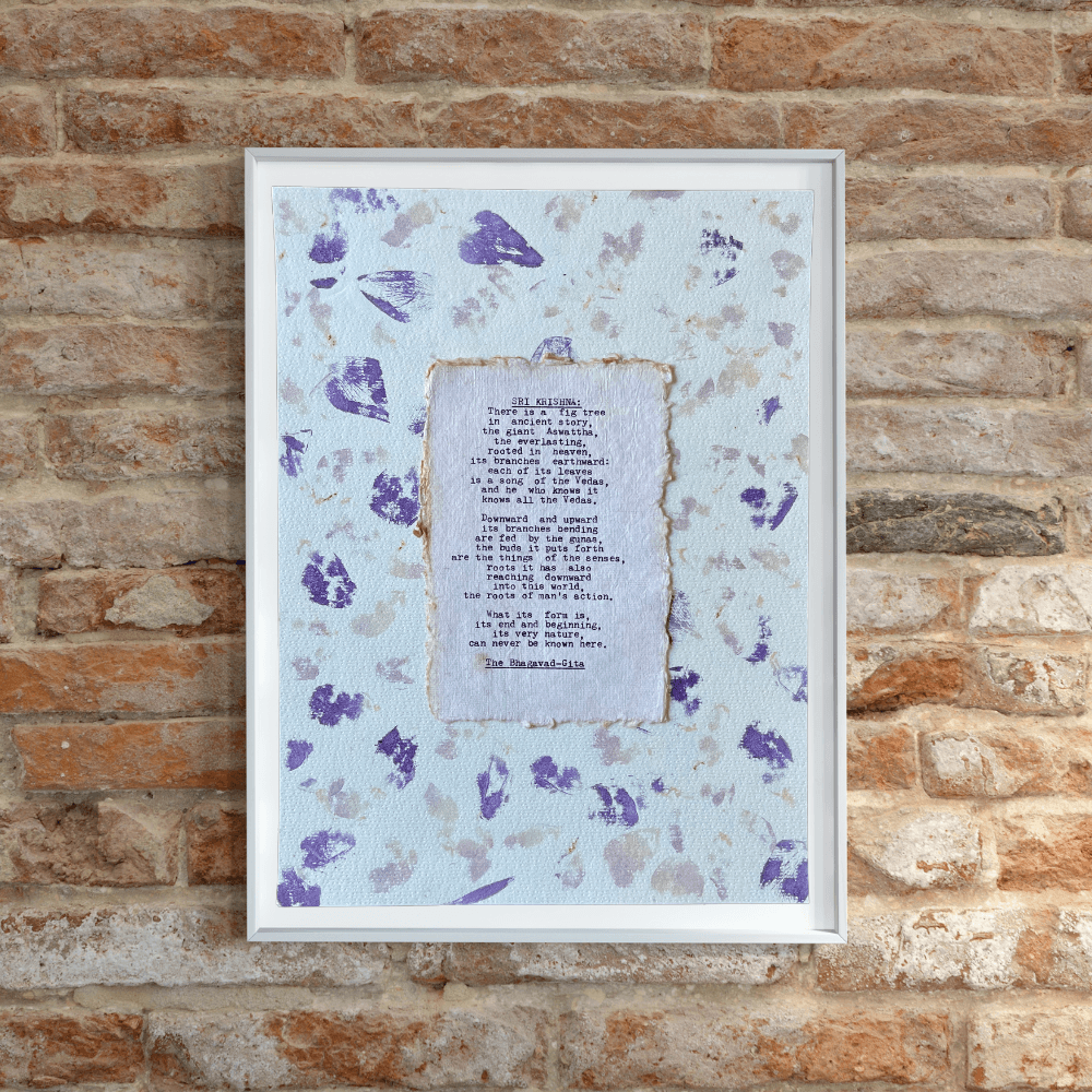 Art made using pigment from real plants depicting a floral backdrop with a typewritten quote from The Bhagavad-Gita on handmade cotton paper on top.