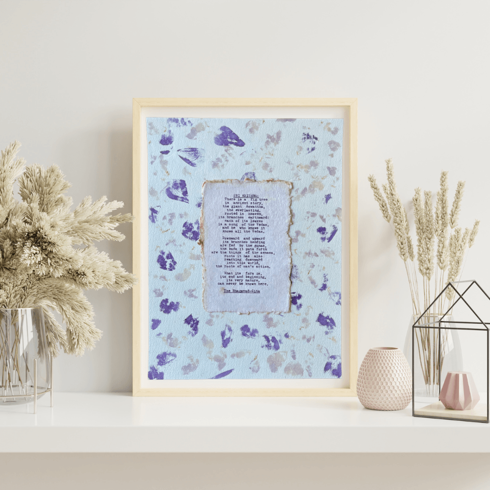 Art made using pigment from real plants depicting a floral backdrop with a typewritten quote from The Bhagavad-Gita on handmade cotton paper on top.