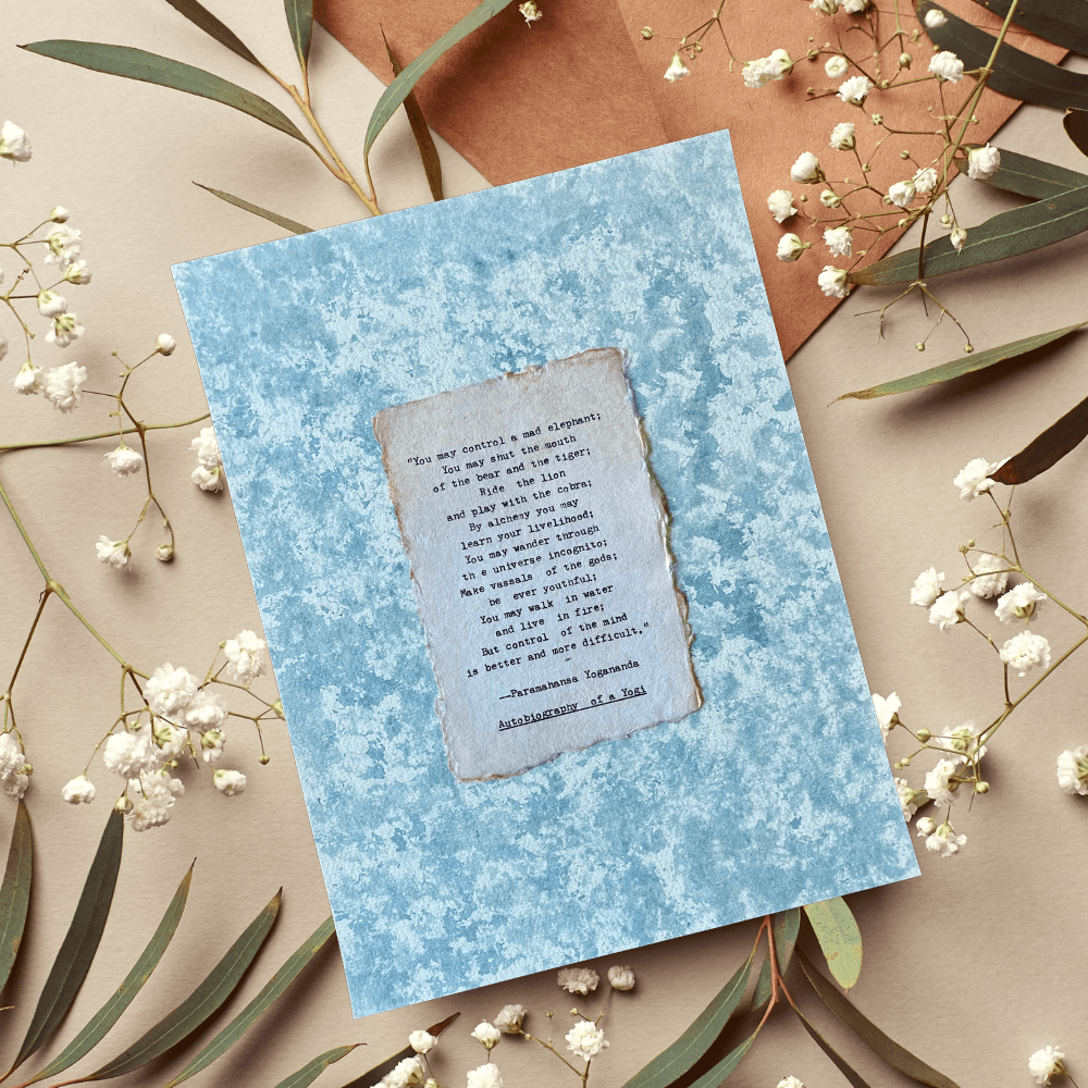 Art made using pigment from real plants depicting a blue backdrop with a typewritten quote by Paramahansa Yogananda on handmade cotton paper on top.