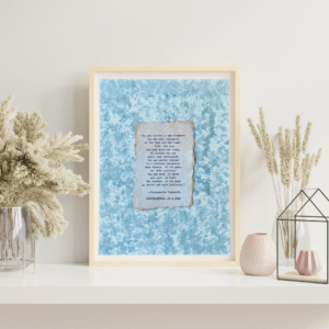 Art made using pigment from real plants depicting a blue backdrop with a typewritten quote by Paramahansa Yogananda on handmade cotton paper on top.