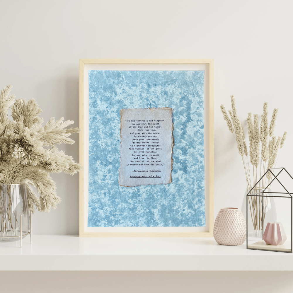 Art made using pigment from real plants depicting a blue backdrop with a typewritten quote by Paramahansa Yogananda on handmade cotton paper on top.