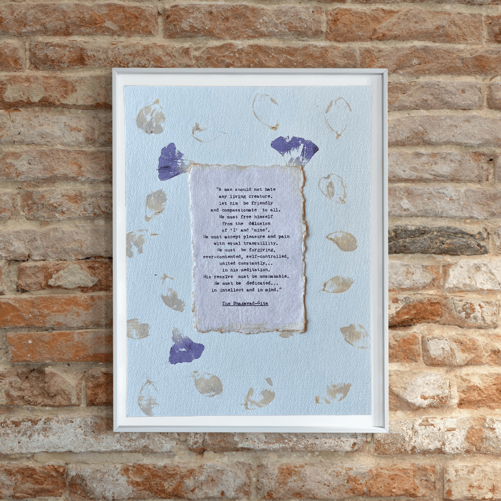 Art made using pigment from real plants depicting a floral backdrop with a typewritten quote from The Bhagavad-Gita on handmade cotton paper on top.