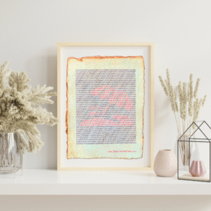 Handmade typewriter art on handmade, recycled, deckled-edged cotton paper. The repeated words, “beach bum” are hand typed in black on a typewriter. The red letters form a visual of a beach scene and umbrella. The piece rests in a neutral frame on a white shelf styled with dried pampas grass, a glass terrarium, and pink textured vases to the sides. At the bottom of the art, the website “www.PlantsAreMyType.com” appears in red.