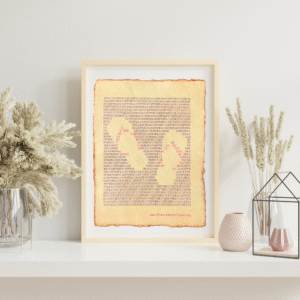 Handmade typewriter art on handmade, recycled, deckled-edged cotton paper. The repeated words, “beach bum” are hand typed in black on a typewriter. Negative space and red letters form a visual of a beach sandals. The piece rests in a neutral frame on a white shelf styled with dried pampas grass, a glass terrarium, and pink textured vases to the sides. At the bottom of the art, the website “www.PlantsAreMyType.com” appears in red.