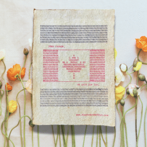 The word, "CANADA" is typed repeatedly on handmade, recycled cotton paper to form an image of the Canadian flag using red and black ink along with negative space. The words, “dear Canada, we hate him too.” frame the flag. The website www.plantsaremytype.com is typed at the bottom right corner of the page. The art sits atop a floral background.