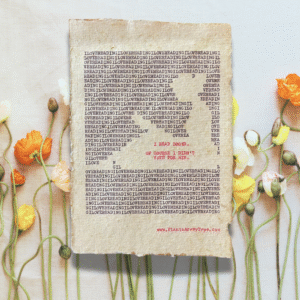 The words, "I Love Reading" are typed repeatedly on handmade, recycled cotton paper to form an image of a person seated, reading a book, using black ink and negative space. The words, “I read books. Of course I didn't vote for him.” are typed in red inside of the outline. The website www.plantsaremytype.com is typed at the bottom right corner of the page. The art sits atop a floral background.