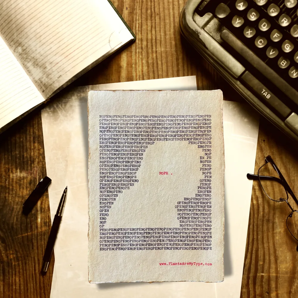 The word, "nope" is typed repeatedly on handmade, recycled cotton paper to form an outline of a man’s right-side portrait using black ink and negative space. The word, “nope.” is typed in red inside of the outline. The website www.plantsaremytype.com is typed at the bottom right corner of the page. The art sits on a wooden desk with a notebook, typewriter, pen, and glasses on the desk.