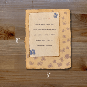 Typewriter art on a wooden background. There are guides showing the paper size, 6"x8". The page is stamped with real flowers and displays a poem about love.