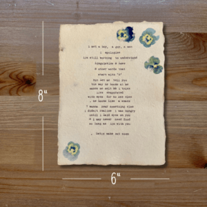 Typewriter art on a wooden background. There are guides showing the paper size, 6"x8". The page is stamped with real flowers and displays a poem about love.
